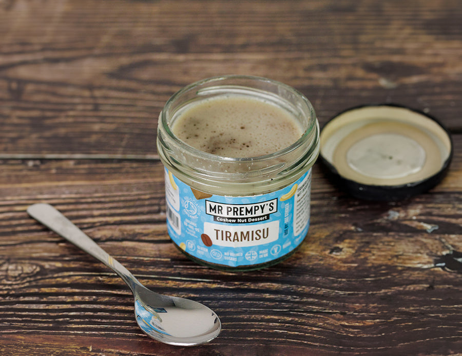 Open jar of Mr Prempy's organic vegan tiramisu dessert with a spoon